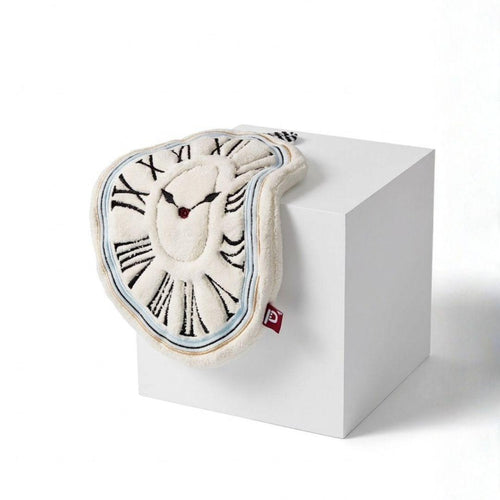 Sculptural clock design hand towel on a white cube with a white background